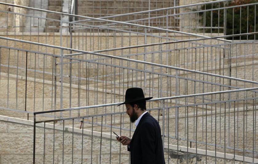 An ultra-Orthodox Jew holds a mobile phone as he walks in Ramat Shlomo, a religious Jewish settlement in an area of the occupied West Bank Israel annexed to Jerusalem, in this May 10, 2010 file photo. Reuters pic