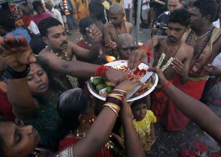 The family of a Hindu devotee pray before beginning her pilgrimage to the sacred Batu Caves temple during Thaipusam festival in Kuala Lumpur on February 8, 2009. u00e2u20acu201d Reuters pic
