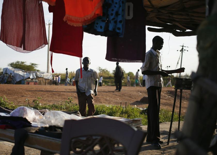 A man cooks in front of a restaurant in downtown Abyei October 25, 2013. u00e2u20acu201d Reuters pic