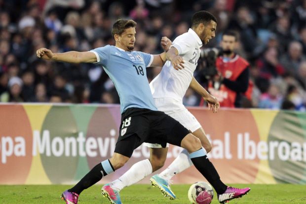 France's Etienne Capoue (R) fights for the ball with Uruguay's Gaston Ramirez during their international friendly soccer match in Centenario Stadium in Montevideo, June 5, 2013. u00e2u20acu201d Reuters pic
