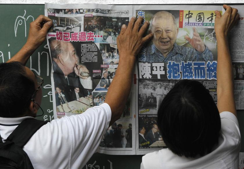 Mourners paste a newspaper featuring pictures of former Malayan Communist Party leader Chin Peng on a board during his funeral at a temple in Bangkok September 20, 2013. — Reuters pic