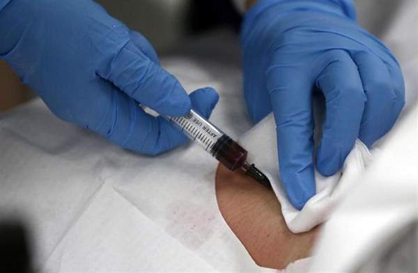 A doctor draws blood from the neck of a patient at an emergency room of a hospital in Shanghai May 15, 2013. u00e2u20acu201d Reuters pic