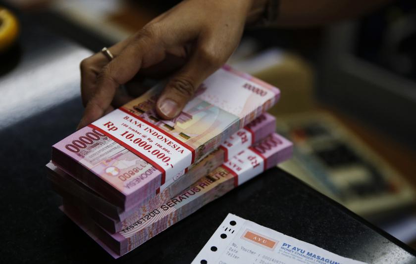File photo of a bank clerk preparing Indonesia rupiah banknotes in Jakarta. u00e2u20acu201d Reuters pic