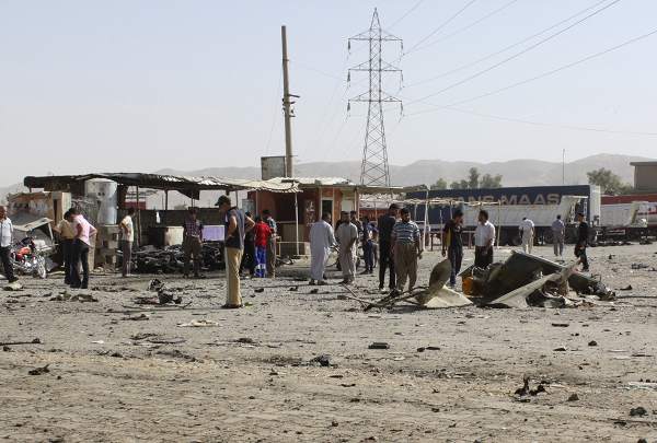 Residents gather at the site of a suicide bomb attack in Tuz Khurmato, 170 km (105 miles) north of the Iraqi capital Baghdad, July 28, 2013. u00e2u20acu201d Reuters pic