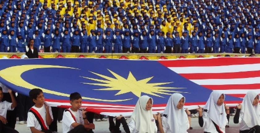 Malaysian youth runs with a national flag during a rally marking the 55th anniversary of Malaysia's independence in Kuala Lumpur. u00e2u20acu201d Reuters pic