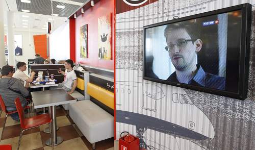 A television screen shows former US spy agency contractor Edward Snowden during a news bulletin at a cafe at Moscow's Sheremetyevo airport June 26, 2013. u00e2u20acu201d Reuters pic