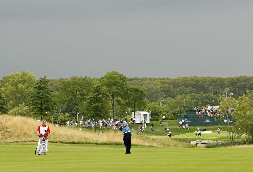 Tiger Woods of the U.S. hits from the 17th fairway under dark skies during the first round of the Barclays PGA golf tournament in Jersey City, New Jersey August 22, 2013. u00e2u20acu201d Reuters pic