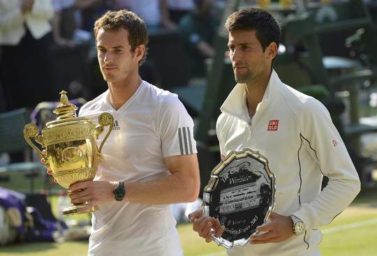Andy Murray of Britain (left) holds the winners trophy, with Novak Djokovic of Serbia holding the runners-up trophy, after defeating him in their men's singles final tennis match at the Wimbledon Tennis Championships, in London July 7, 2013. u00e2u20acu201d Reuters p