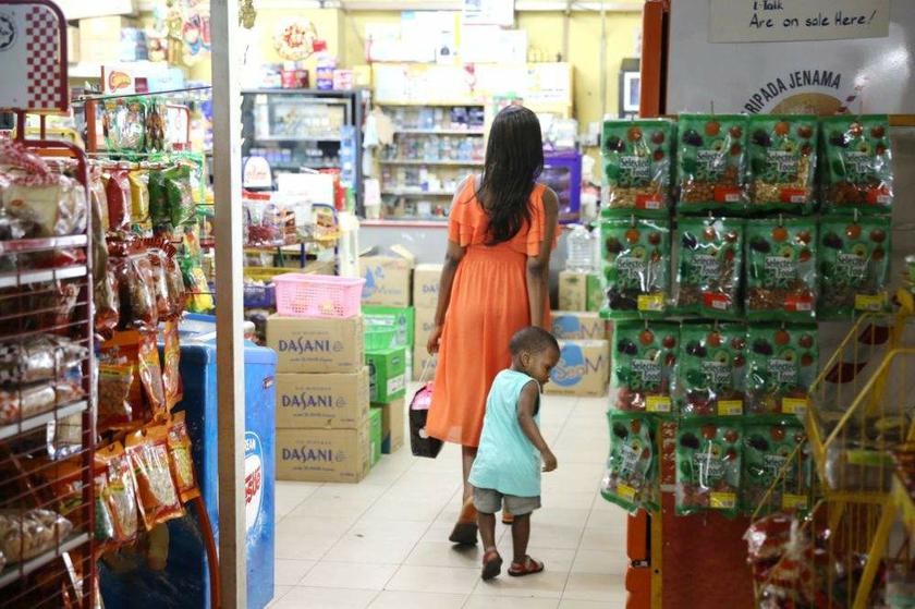 A foreign woman and her child seen in the convenience shop at Ridzuan Condominium.