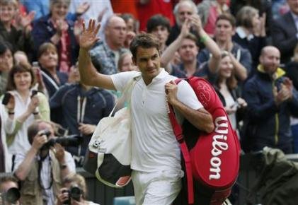 Roger Federer of Switzerland walks off the court after being defeated by Sergiy Stakhovsky of Ukraine in their men's singles tennis match at the Wimbledon Tennis Championships, in London June 26, 2013. - Reuters pic