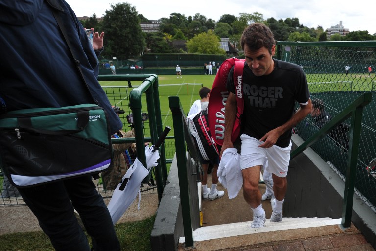Switzerland's Roger Federer  leaves a practice court after a training session at the All England Tennis Club in Wimbledon, southwest London, on June 23, 2013. u00e2u20acu201c AFP pic