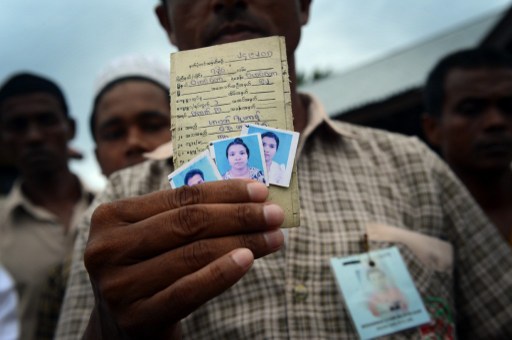 In this photograph taken on April 11, 2013, Rohingya asylum-seeker Mohammad Zuhar bin Sayed Alam displays pictures of his wife Nuranki (centre) and sister Rajuma (right) he left behind in Myanmar. u00e2u20acu201d AFP pic