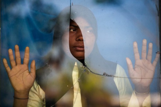 File photo of an ethnic Rohingya refugee who was among a boatload of asylum seekers standing by the window of an immigration quarantine centre in Langsa district in Aceh province. u00e2u20acu201d AFP pic