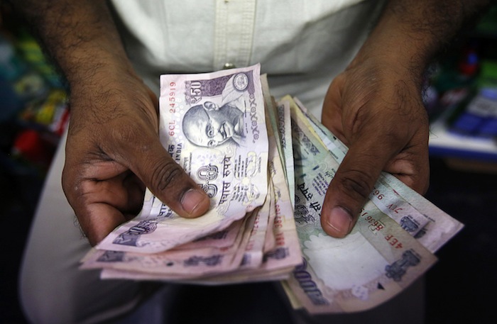 A private money trader counts Indian Rupee currency notes at a shop in Mumbai, in this August 1, 2013 file photo. u00e2u20acu201d Reuters pic