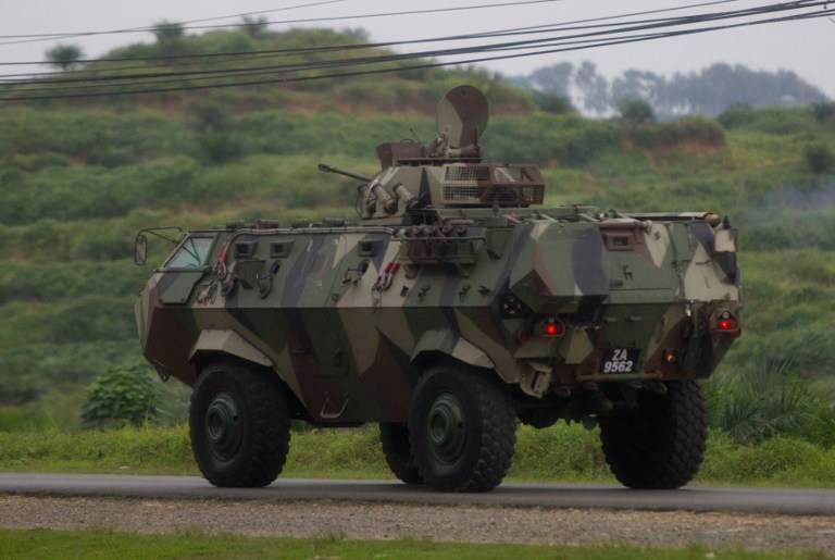 Malaysian soldiers with in an armoured personnel carrier drive towards the area where the stand-off with Sulu gunmen is on going, in Tanduo village, Sabah on March 4, 2013. u00e2u20acu201d AFP pic