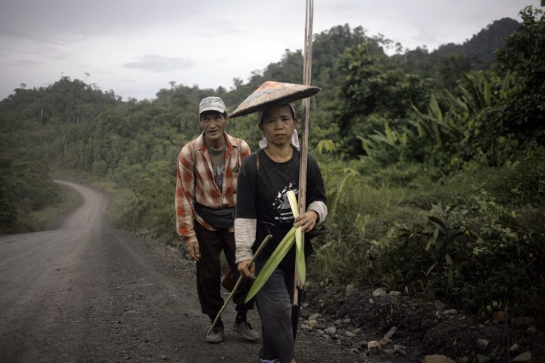 This picture taken on July 21, 2010 shows a Penan tribe members walking towards their hut in the Ulu Baram district of Sarawak. u00e2u20acu201c AFP pic