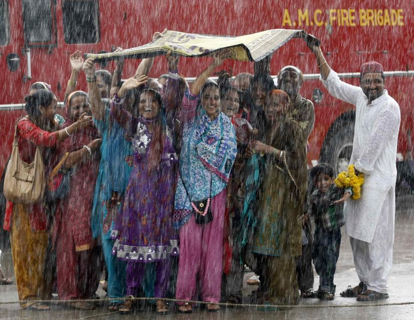Relatives of Haj pilgrims wave in the rain, as they see off their relatives who are leaving Ahmedabad for Mecca in Saudi Arabia to take part in the annual religious Haj pilgrimage, September 26, 2013. u00e2u20acu201d Reuters pic