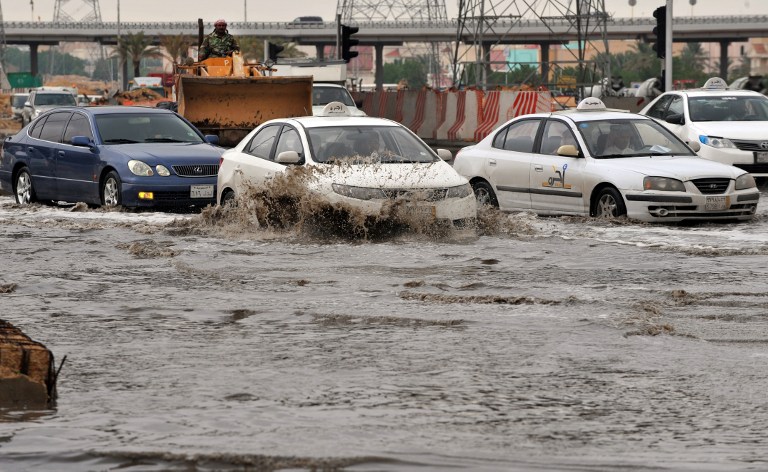 Cars drive through a flooded street in northern Riyadh, on November 17, 2013, after heavy rains caused floods and traffic jams which forced the Saudi Eduction Ministry to suspend studies in schools and universities for one day. u00e2u20acu201d AFP pic