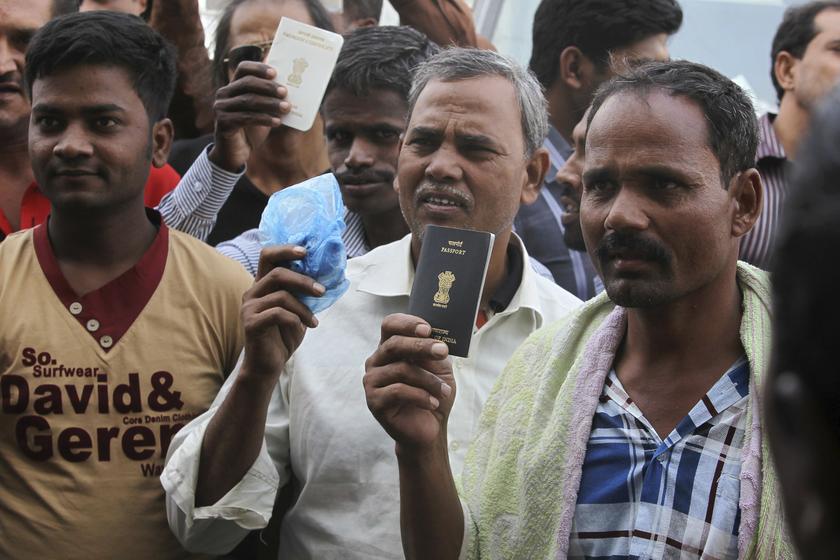 Foreign workers hold their passports as they gather outside a labour office, after missing a deadline to correct their visa status, in Riyadh November 4, 2013. u00e2u20acu2022 Reuters pic