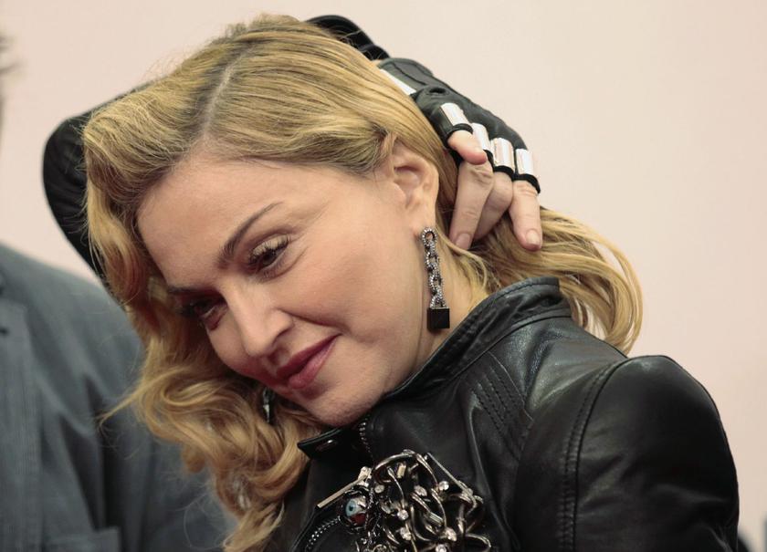 U.S. singer Madonna arrives to promote her latest gym in her Hard Candy Fitness centre chain in Berlin October 17, 2013 Reuters