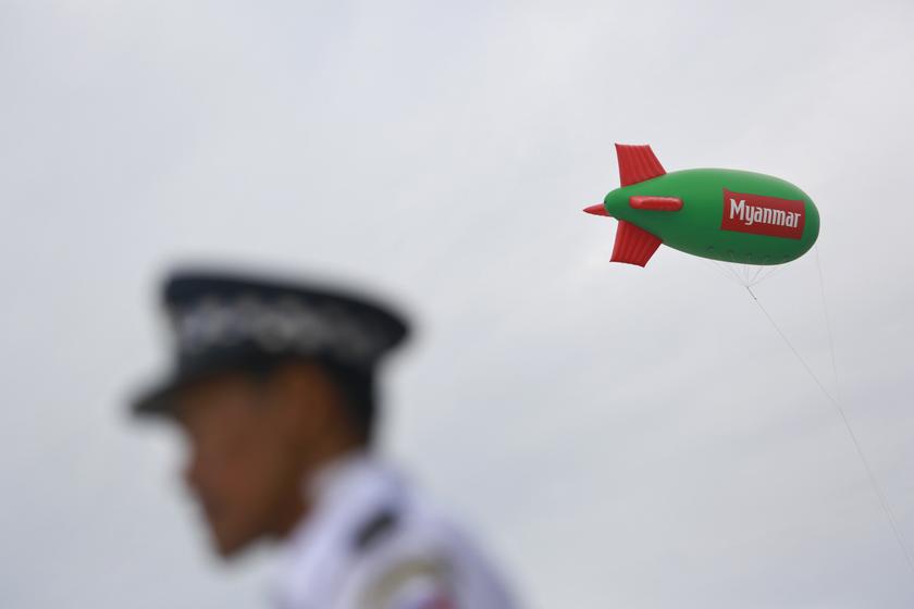 An advertisement balloon of the 27th Southeast Asian (SEA) Games is pictured above a stadium as a police stands guard nearby in Naypyitaw December 10, 2013. u00e2u20acu201d Reuters pic