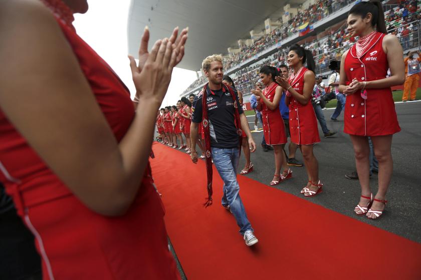 Grid girls clap as Red Bull Formula One driver Sebastian Vettel of Germany walks on a red carpet during the Indian F1 Grand Prix at the Buddh International Circuit in Greater Noida, on the outskirts of New Delhi, October 27, 2013. u00e2u20acu201d Reuters pic