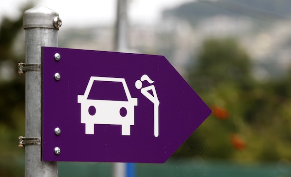 A sign showing the way to the prostitutes stands is seen during an open day at a sex drive-in, west of Zurich August 24, 2013. — Reuters pic