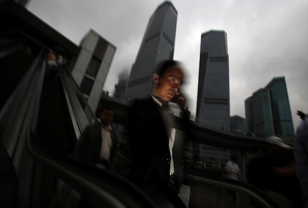 A businessman talks on his mobile phone as he walks in the financial area of Pudong in Shanghai May 30, 2013. u00e2u20acu201d Reuters pic