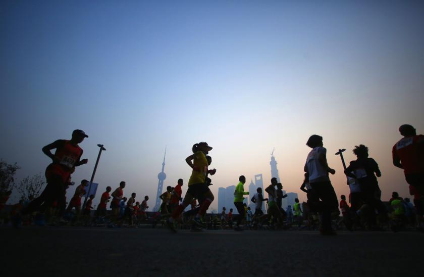 Participants run on the Bund near Huangpu River as they compete in the Shanghai International Marathon December 1, 2013. u00e2u20acu201d Reuters pic