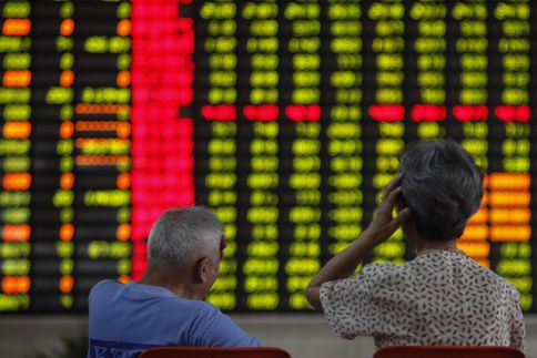 Investors sit in front of an electronic board showing stock information at a brokerage house in Shanghai June 25, 2013. u00e2u20acu201d Reuters pic