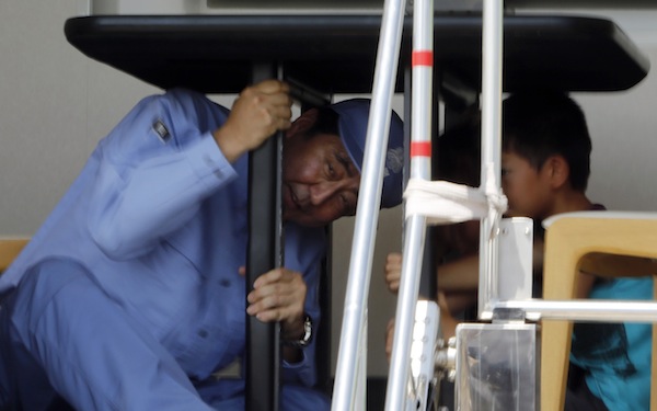 Japanu00e2u20acu2122s Prime Minister Shinzo Abe takes shelter under a table inside a shaking earthquake simulator during an annual anti-disaster drill in Chiba, west of Tokyo Sept 1, 2013. u00e2u20acu201d Reuters pic