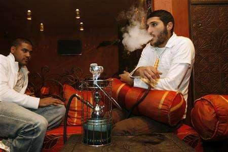 Lucas Hurnaum (left) and Adnene Daabak smoke a shisha pipe in the Touareg shisha cafe in Paris November 22, 2007. u00e2u20acu201c Reuters pic