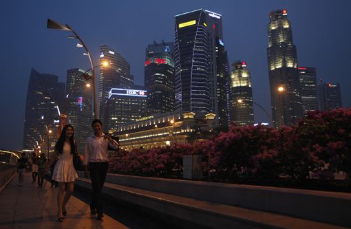 A couple walks past Singaporeu00e2u20acu2122s central business district. u00e2u20acu201d AFP file pic