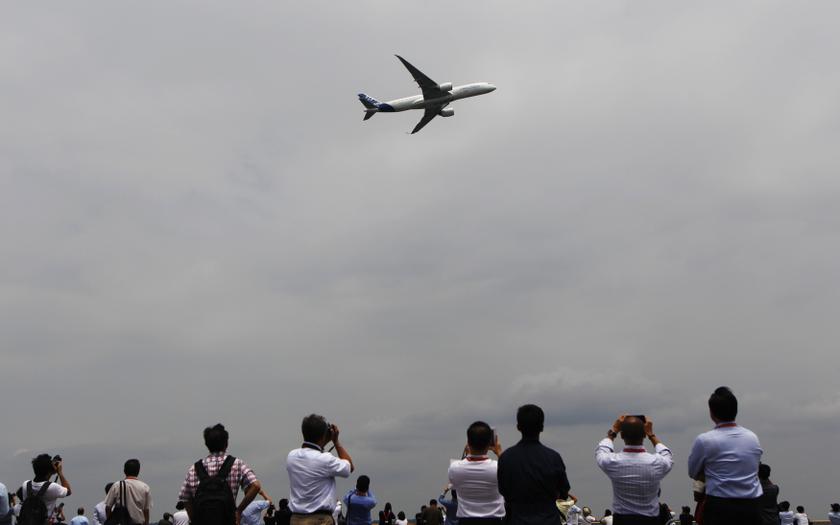 Visitors take photos as an Airbus A350 passes during an aerial display at the Singapore Airshow February 11, 2014. u00e2u20acu201d Reuters pic