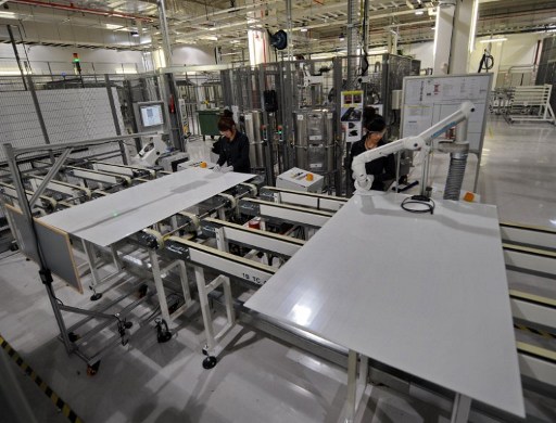 Employees make solar panels in a manufacturing facility in Singapore on November 3, 2010. u00e2u20acu201d AFP pic