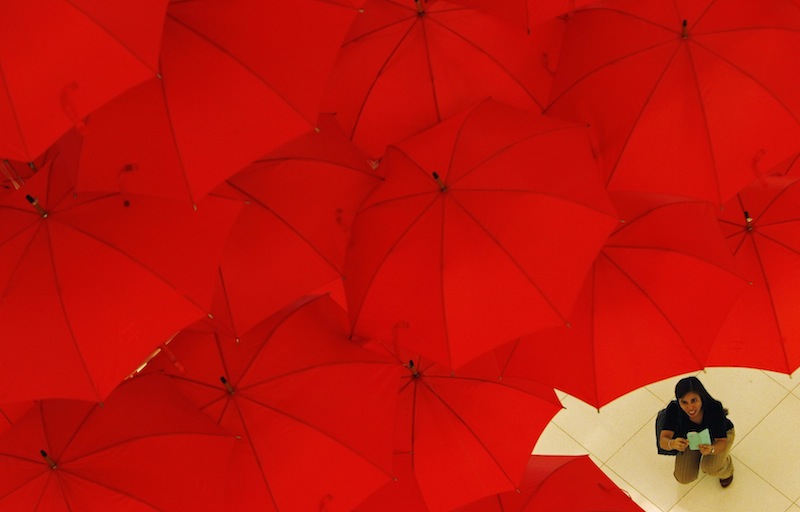 A woman takes photos of an art installation titled u00e2u20acu02dcUnited 65u00e2u20acu2122 by Singaporean artist Ryf Zaini at a mall in Singapore August 9, 2013. u00e2u20acu201d Reuters pic