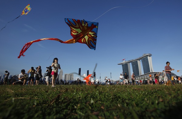 People fly kites during the annual Singapore Kite Festival at the central business district area of Marina Bay in Singapore August 31, 2013. u00e2u20acu201d Reuters pic