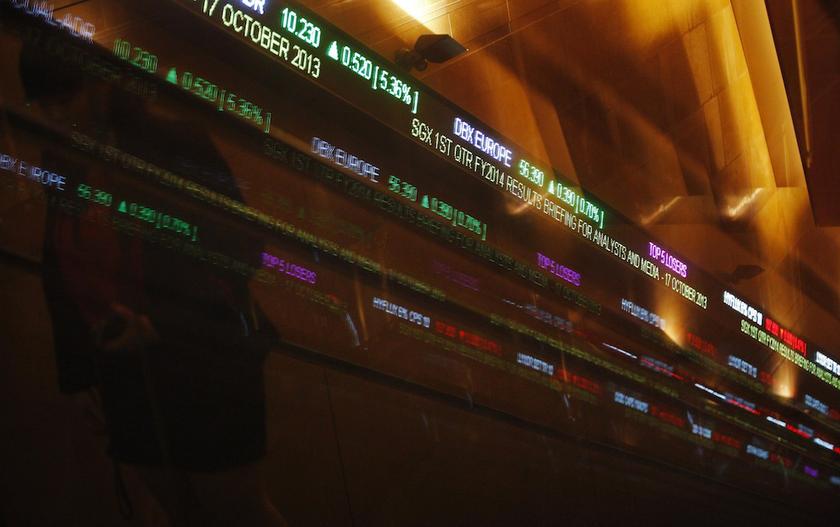 A woman passes stock index tickers at the Singapore Exchange (SGX) premises in Singapore October 17, 2013. u00e2u20acu201d Reuters pic