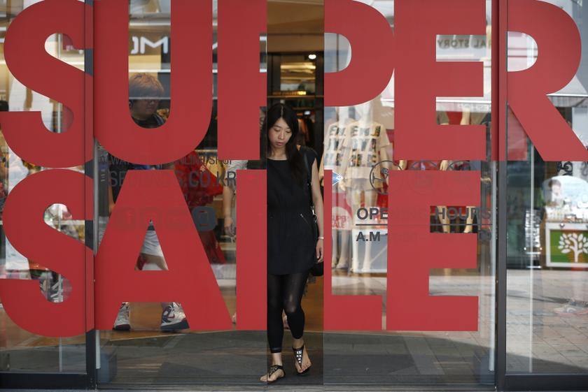 A woman leaves a shopping mall in central Seoul July 31, 2013. u00e2u20acu201c Reuters pic