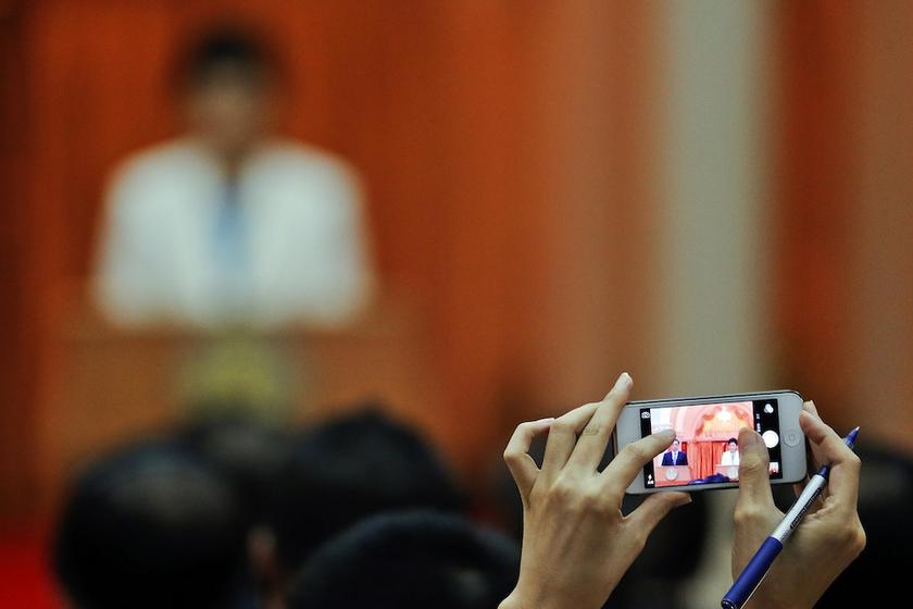 A reporter takes pictures of Thailand's Prime Minister Yingluck Shinawatra and Chinau00e2u20acu2122s Premier Li Keqiang as they address the press at the government house in Bangkok October 11, 2013. u00e2u20acu201d Reuters pic