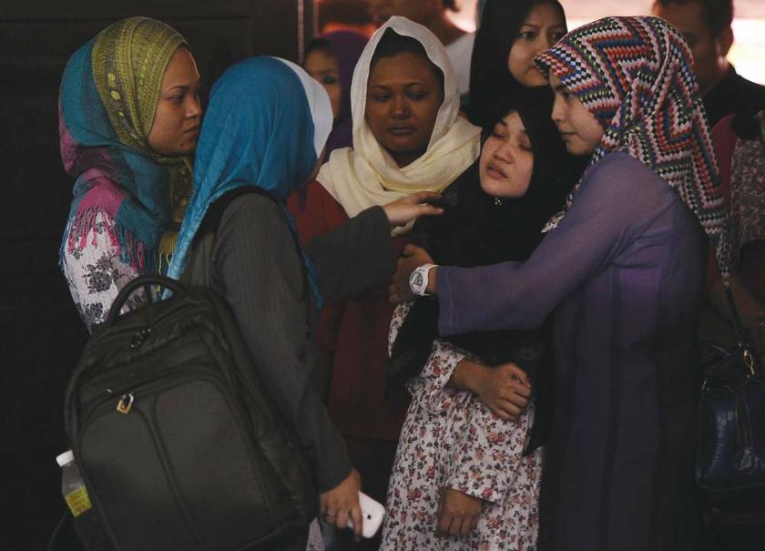 Family members and friends console the victimu00e2u20acu2122s sister, Nurul Hana (second from right), at Masjid Nurul Hidayah, Kampung Pandan in Kuala Lumpur on August 29, 2013. u00e2u20acu201d Picture by Shahir Omar