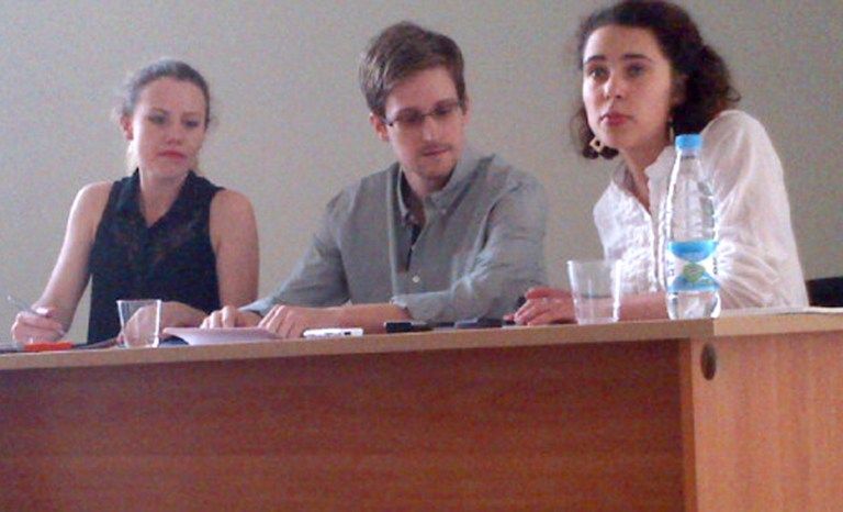 US National Security Agency (NSA) fugitive leaker Edward Snowden (C) during a meeting with rights activists, with among them Sarah Harrison of WikiLeaks (L), at Moscow's Sheremetyevo airport, on July 12, 2013.