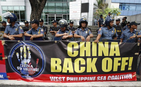 Anti-riot policemen stand guard in front of a banner during the u00e2u20acu0153Global Day of Actionu00e2u20acu009d protest against Chinau00e2u20acu2122s claims in the South China Sea, in front of the Chinese consular office in Makati city, metro Manila July 24, 2013.u00e2u20acu201dReuters pic