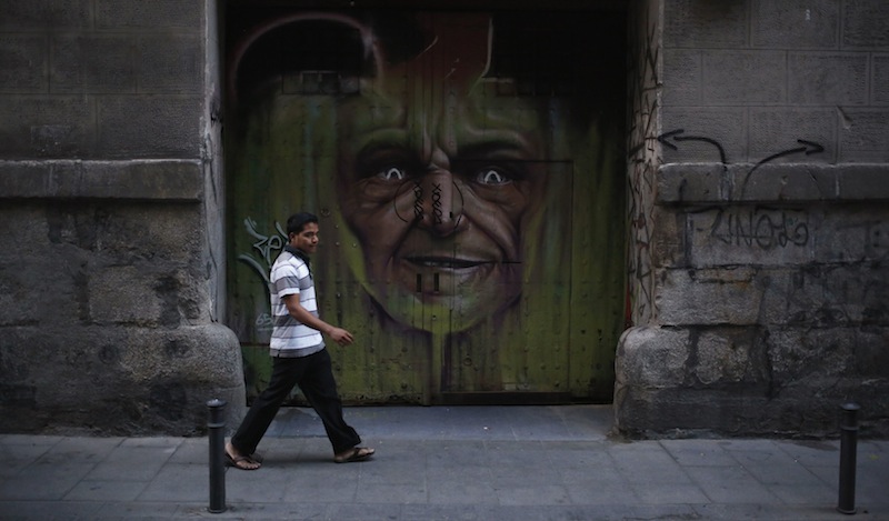 A man walks past a closed down shop in Madrid July 27, 2013. u00e2u20acu201d Reuters pic