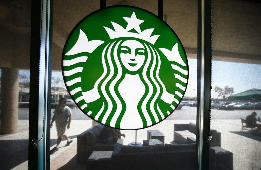 A Starbucks logo hangs on a window at a newly designed Starbucks coffee shop in Fountain Valley, California August 22, 2013. u00e2u20acu201d Reuters pic