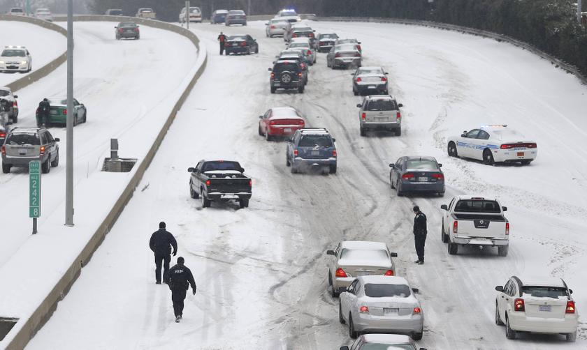 Charlotte Mecklenburg Police Officers work to assist motorists as they attempt to drive up a hill that is covered in snow in Charlotte, North Carolina February 12, 2014. u00e2u20acu201d Reuters pic