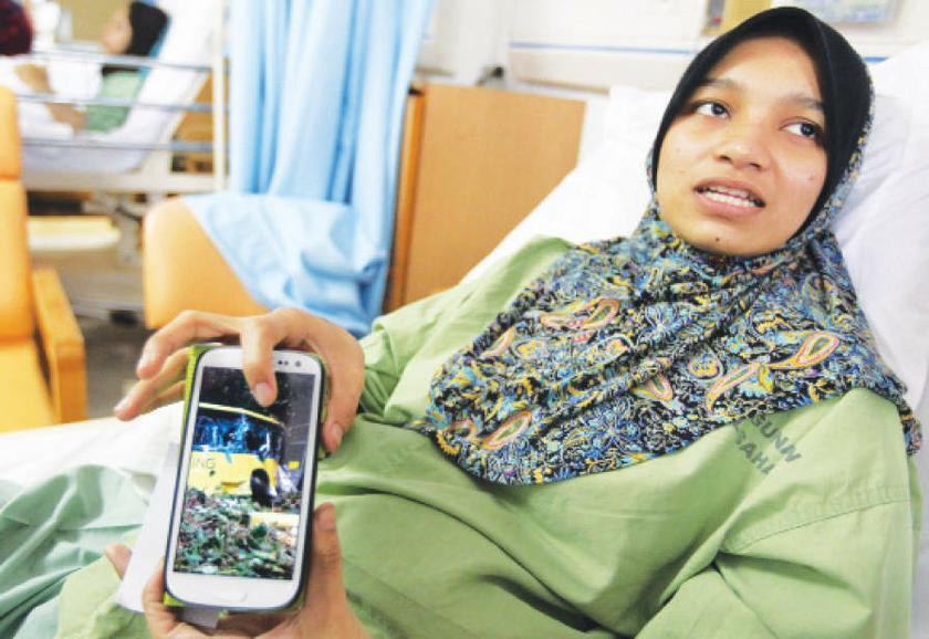 Survivor Nur Fatihah Jau00e2u20acu2122afar shows a picture she took after the Genting Highlands bus accident. u00e2u20acu201d The Malay Mail pic