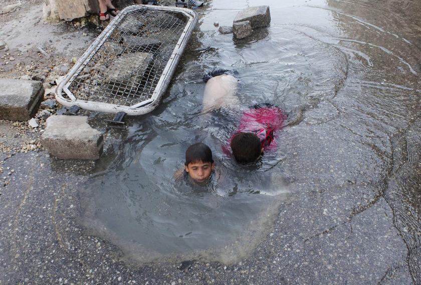 Children play with water from a burst water pipe in the old city of Aleppo August 15, 2013. u00e2u20acu201c Reuters pic