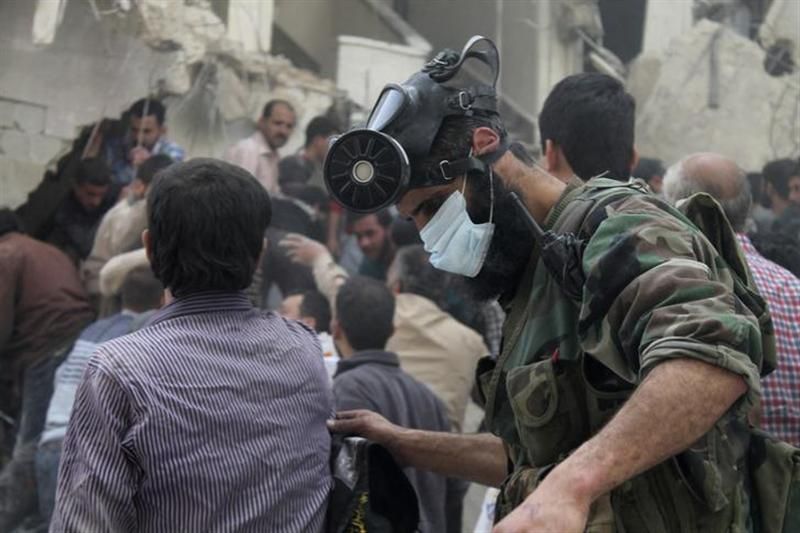 A man, with a chemical mask on his head, searches for survivors from the rubble of a damaged area, what activists said was a result of an airstrike by the Syrian Regime, in Al-Sukkari neighbourhood in Aleppo April 7, 2013. u00e2u20acu201d Reuters pic