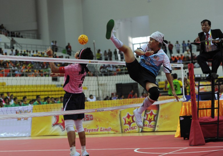 Nurrashidah Abdul Rashid (right) from Malaysia attempts a block as Mega Citra from Indonesia heads during the Sepaktakraw women's event during the 27th Southeast Asian Games in Naypyidaw on December 12, 2013. u00e2u20acu201du00c2u00a0AFP pic